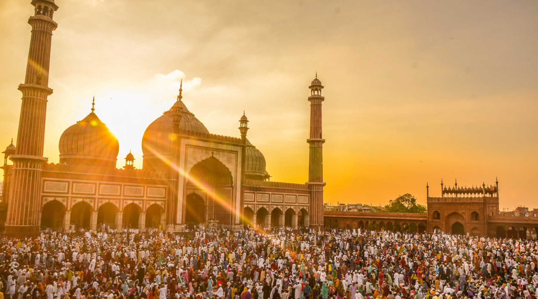 photo of people in front of mosque during golden hour