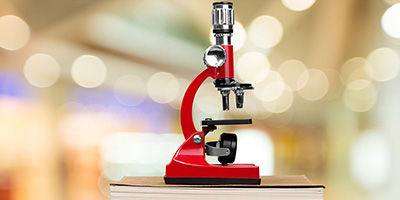 microscope atop books