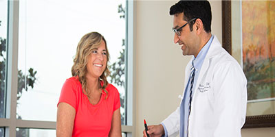 medical professional with patient in examination room